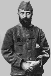 photographie noir et blanc : portrait d'homme barbu, en uniforme, un calot sur la tête