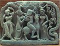 Satyr on a mountain goat, drinking with women, in a Gandhara relief of 2nd–4th century CE.