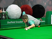 Thorburn playing a shot at a snooker table