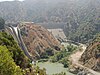 View of a reservoir at the bottom of a steep arid canyon