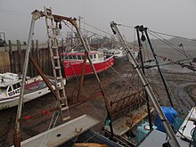 Photo of boat in water next to a dock