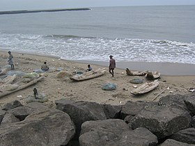 Fishermen mending nets and catamarans in Kasimedu