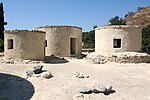 Small white circular huts with flat roof.