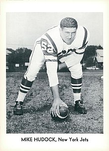 Black and white photo of Hudock about to snap a football