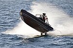 A Danish navy RHIB making speed through water.