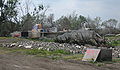 Survivors live in tent on ruined foundation where their house was, 7 months after storm. Near Reggio.