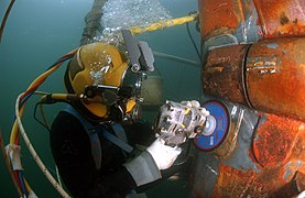 A US Navy diver at work. The umbilical supplying air from the surface is clearly visible