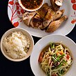 Som tam (papaya salad), khao niao (sticky rice) and kai yang (grilled chicken)