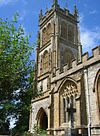 Stone building with arched windows and square tower.