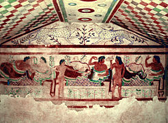 Frescos etruscos de la tumba de los lleopardos» (Tarquinia), onde se representa un simposion, costume social de clara influencia griega, representáu equí col coloríu y la concepción festiva propios de la pintura etrusca. Los etruscos desenvolvieron una civilización con carauterístiques orientalizantes dientro del contestu itálicu, del que fueron la potencia dominante hasta que Roma, la capital llatina que tuvo sometida a reis etruscos (Monarquía romana), terminó imponiéndose nos primeros tiempos de la República (del sieglu V al III e.C. ).