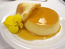 A tuile arced over a creme caramel dessert