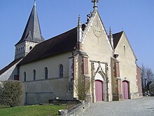 Vue d'ensemble de l'église paroissiale. Ici : la nef, le portail, le clocher-tour et le parvis de l'édifice religieux illois.