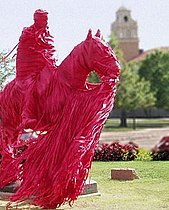 Will Rogers and Soapsuds statue wrapped in red crepe paper for gameday