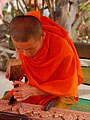 Image 24Lao monk woodworking temple details (from Culture of Laos)