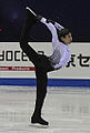 A man performing the Biellmann spin (Denis Ten)