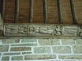 Le Faouët (Morbihan) : chapelle Saint-Sébastien, bas-relief d'une sablière représentant deux hommes tête-bêche tenant un bâton