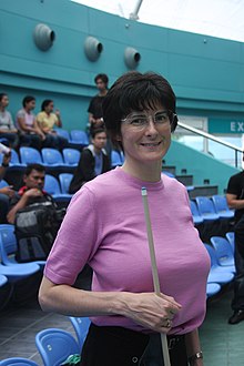 A woman holding a pool cue