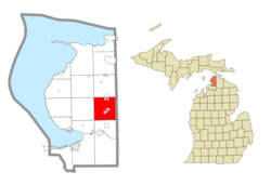 Location within Emmet County and the administered community of Brutus (1) and portion of the village of Pellston (pink)