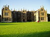 Three bay house with multiple windows, pinnacles and chimneys