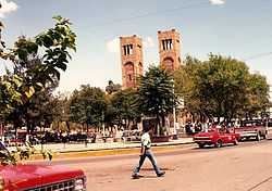 The Plaza Guillermo Baca in downtown Parral in 1992, showing the Searcher of Dreams Fountain and the Cathedral Shrine of Our Lady of Guadalupe, seat of the Diocese of Parral