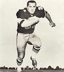 Black and white photo of Taylor rushing a football