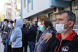 Crowds outside of their buildings.