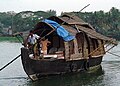 A houseboat in the backwaters. Originally they were (about 2 decades back) used as carrier of goods - mainly the agricultural produce like rice, coconut and the industrial goods like clay, coir and tiles. Currently they are re modified as floating houses, a main attraction in the Kerala tourism.