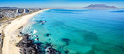 An aerial view of Bloubergstand with Table Mountain on the far side of Table Bay.