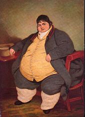 Smartly dressed fat man with dark hair sitting on a chair