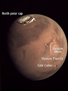 Photo de la planète montrant la position de Elysium Planitia, région dans laquelle se situe la zone d'atterrissage.