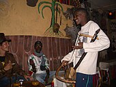 Lalibela, Ethiopia, 2005. An azmari (minstrel) plays a manenqo, bowed lute.