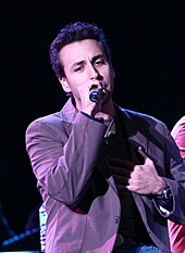 A close-up image of Dorough performing on stage