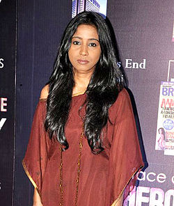 Shilpa Rao looking at the camera in a maroon dress