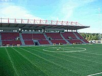 Empty stadium stands, seen from across the pitch