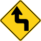 U.S. and Canada sharp reverse turns ahead sign.