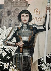 Joan of Arc depicted with short black hair in full body armor holding a flag and a sword; the breastplate reads "Jesus and Mary" in Latin