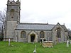 Gray stone building with square tower and slate roof.