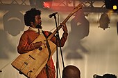 Madagascar, 2013. Musician playing a kabosy.