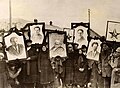 Image 28Russian peasants holding banners of Lenin (left), Marx (centre) and Trotsky (right) in early Soviet Russia. (from Russian Revolution)