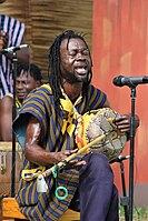 Ghana, 2023. Musician playing a kolog.