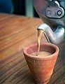 Indian Masala chai served in a red clay tea cup.