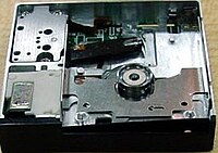 DataPlay optical drive engine internals viewed from above a unit produced without any top cover; above the circular piece is the laser pickup. The laser pickup is built on a piece of silicon.[18]