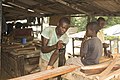 Menuisier en train de scier du bois dans la ville d'Abidjan en Côte d'Ivoire