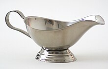 A metal gravy boat