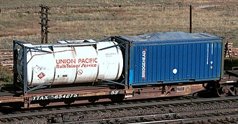 A spine car with a 20 ft tanktainer and an open-top 20 ft container with canvas cover