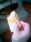 Joss paper folded and ready to be burned as an offering