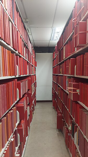 File:Bookshelves of red-covered journals.jpg