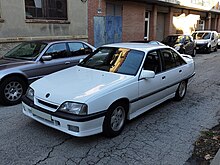 A white Opel Omega 3000 from 1989.