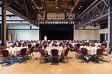 A dinner and event hall with a stage at the front