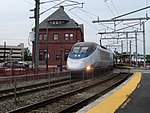 An Acela train passes New London Union Station in 2012